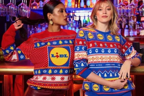 The Lidl Christmas jumper with Lidl logo in red colour and blue Lidl print Christmas jumper